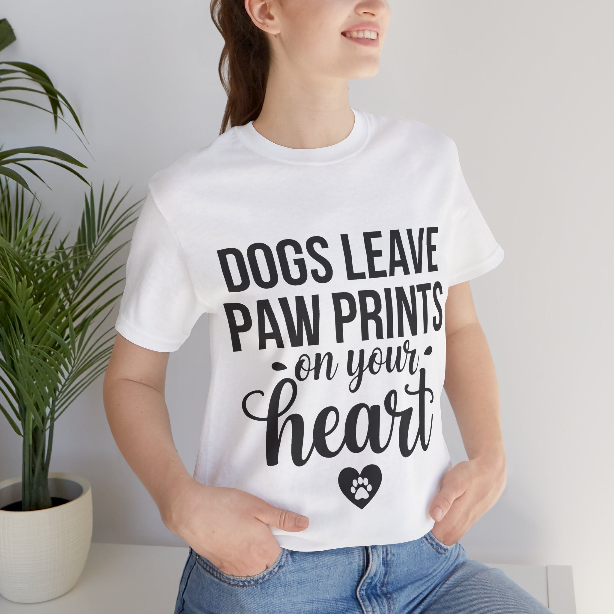 Person wearing a white t-shirt with a motivational quote about dogs.