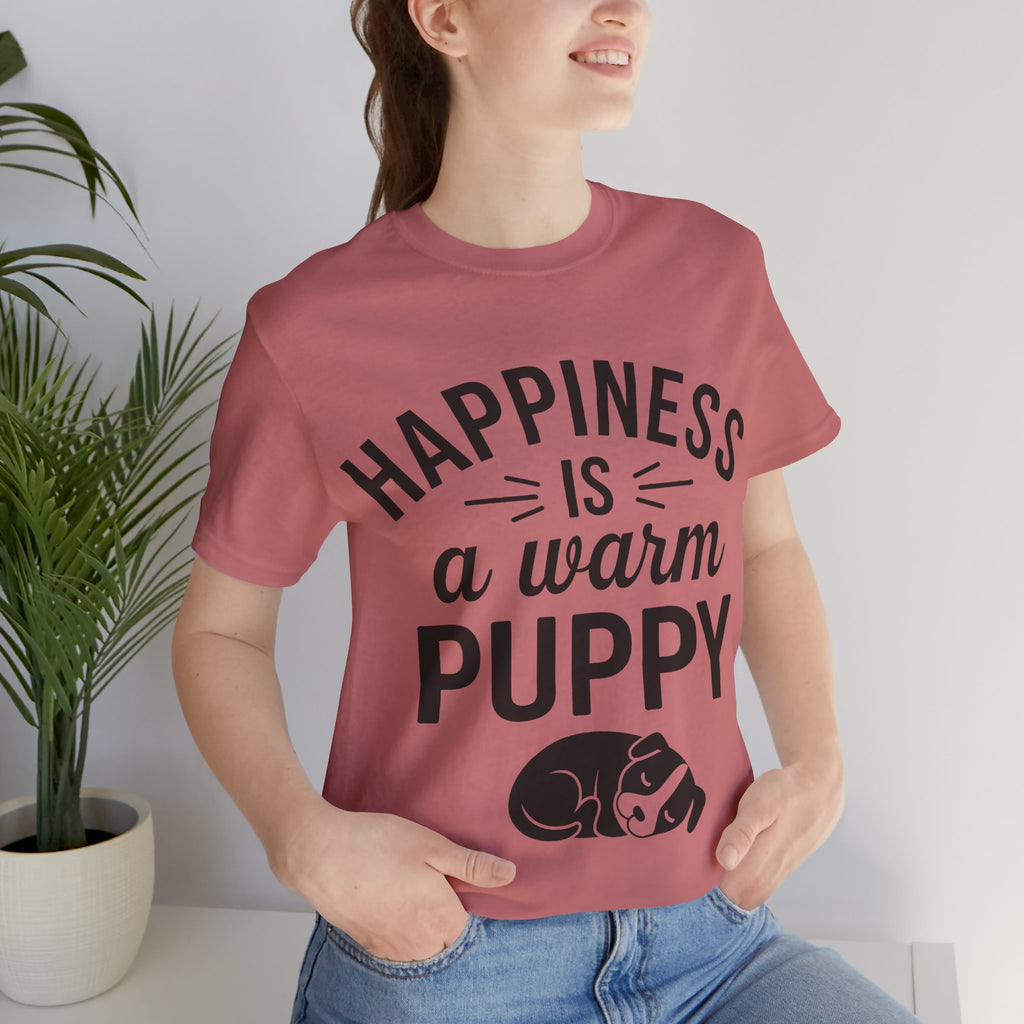 Person wearing a t-shirt with 'Happiness is a warm puppy' text and graphic.