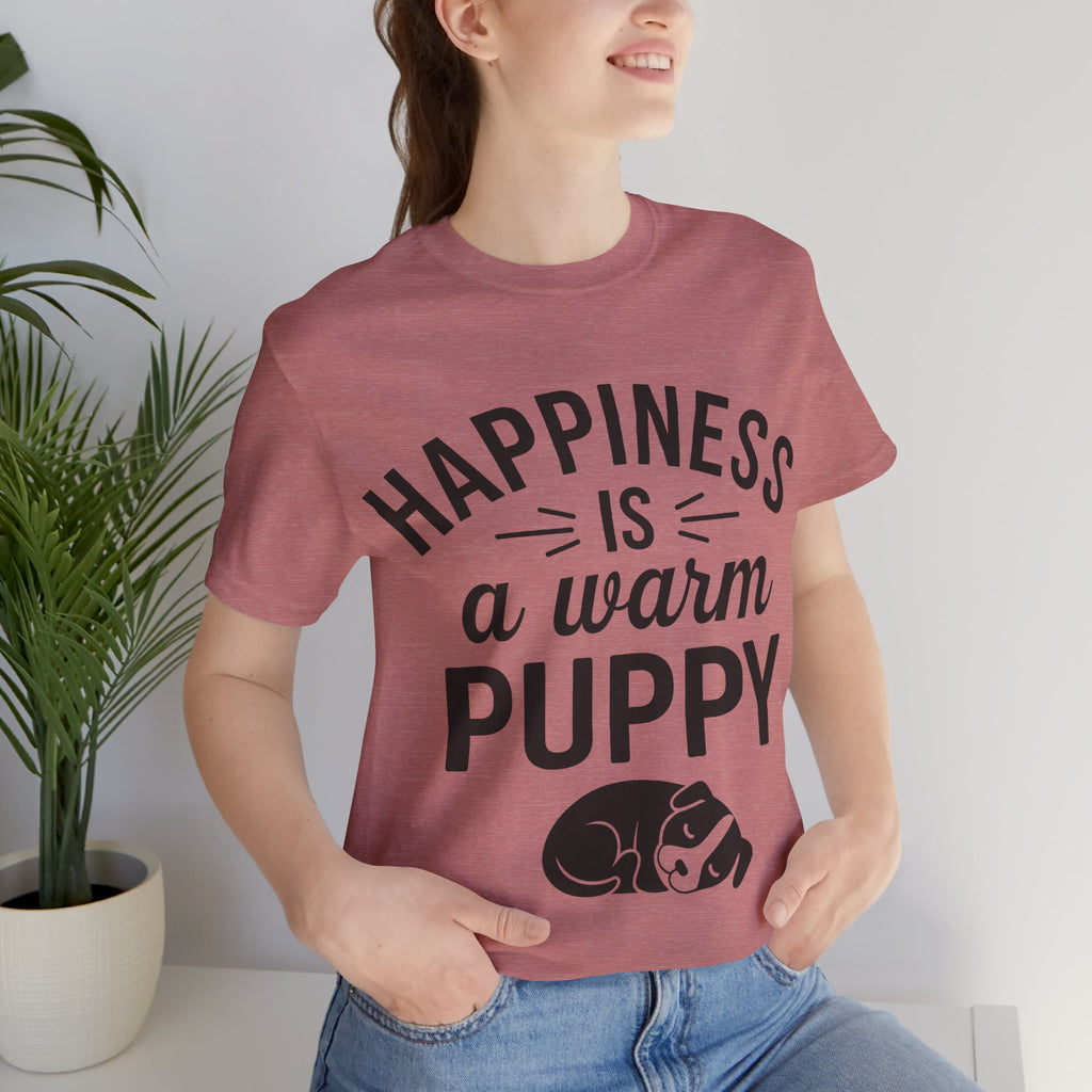 Person wearing a t-shirt with 'Happiness is a warm puppy' text and graphic.