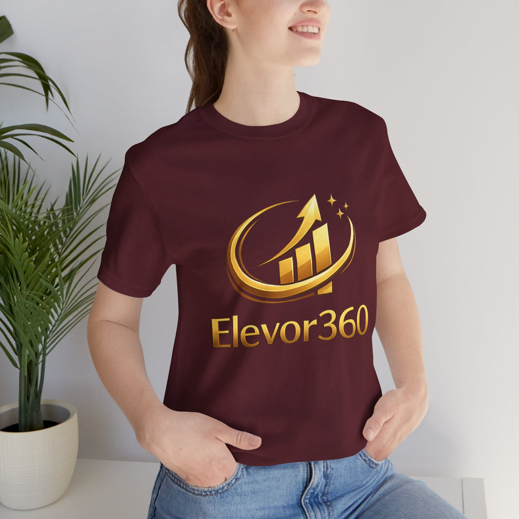 Person wearing a maroon t-shirt with 'Elevor360' logo in gold.