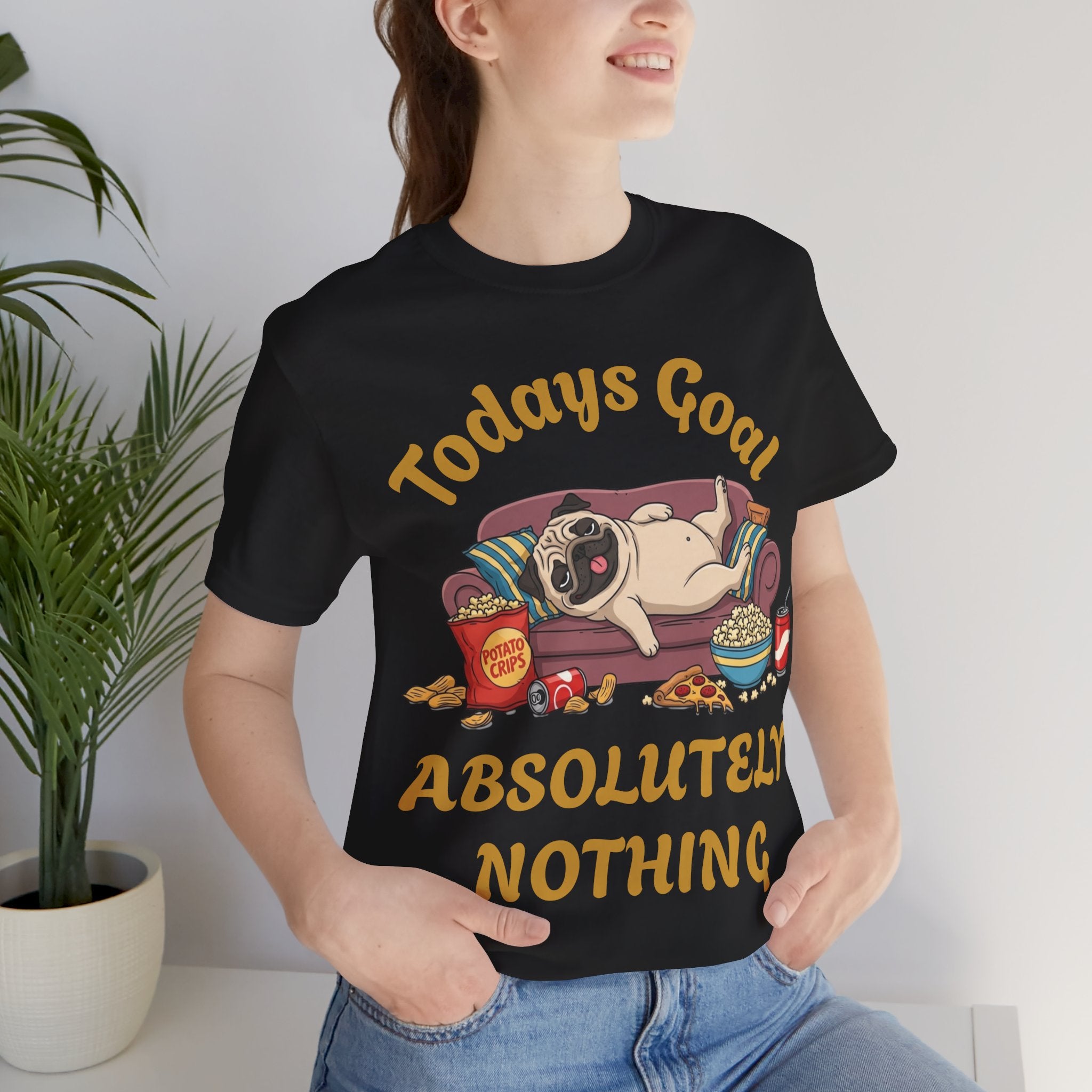 Elevor360 - Person wearing a black t-shirt with a graphic of a pug and text, sitting indoors.
