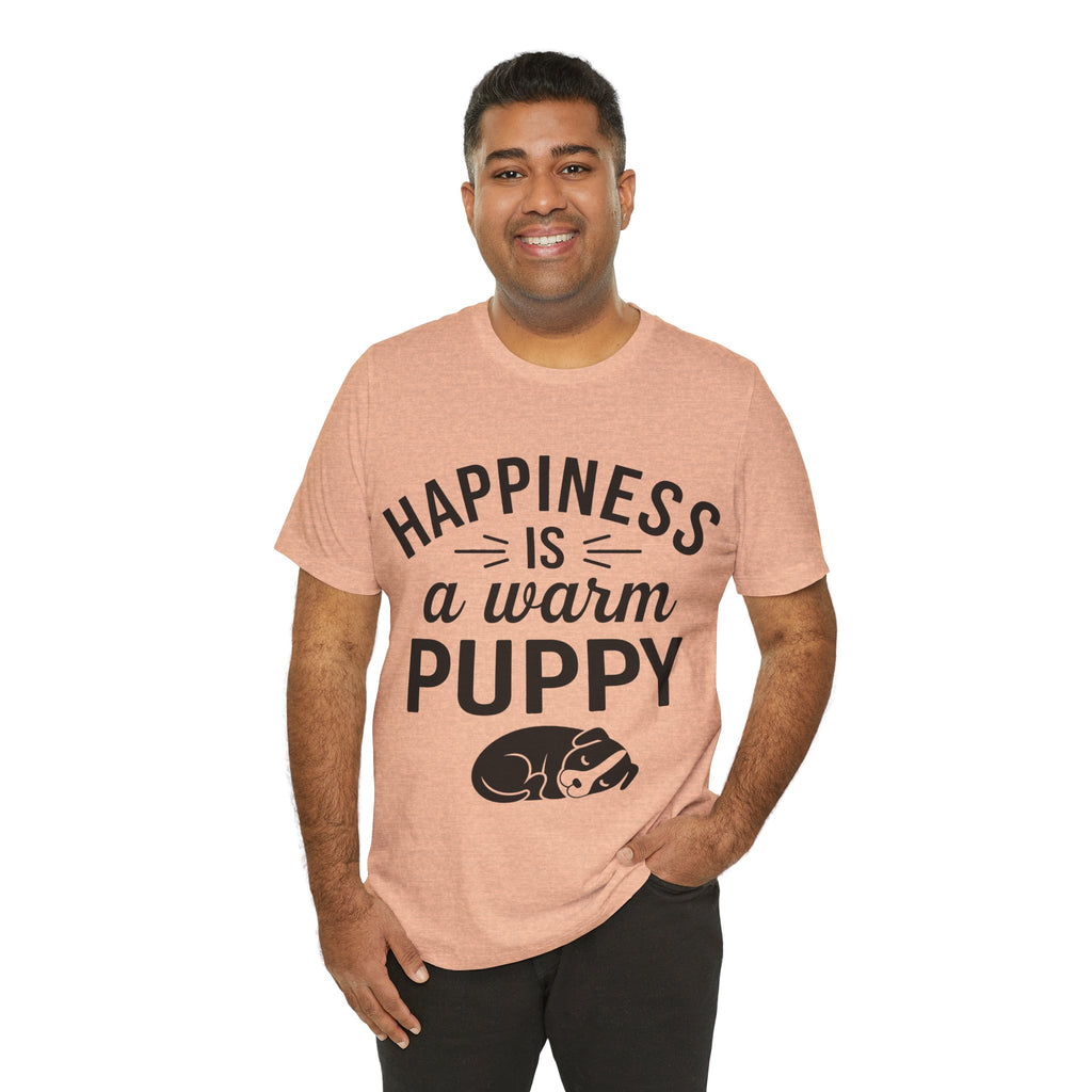 Man wearing a pink t-shirt with 'Happiness is a warm puppy' text and graphic on a white background