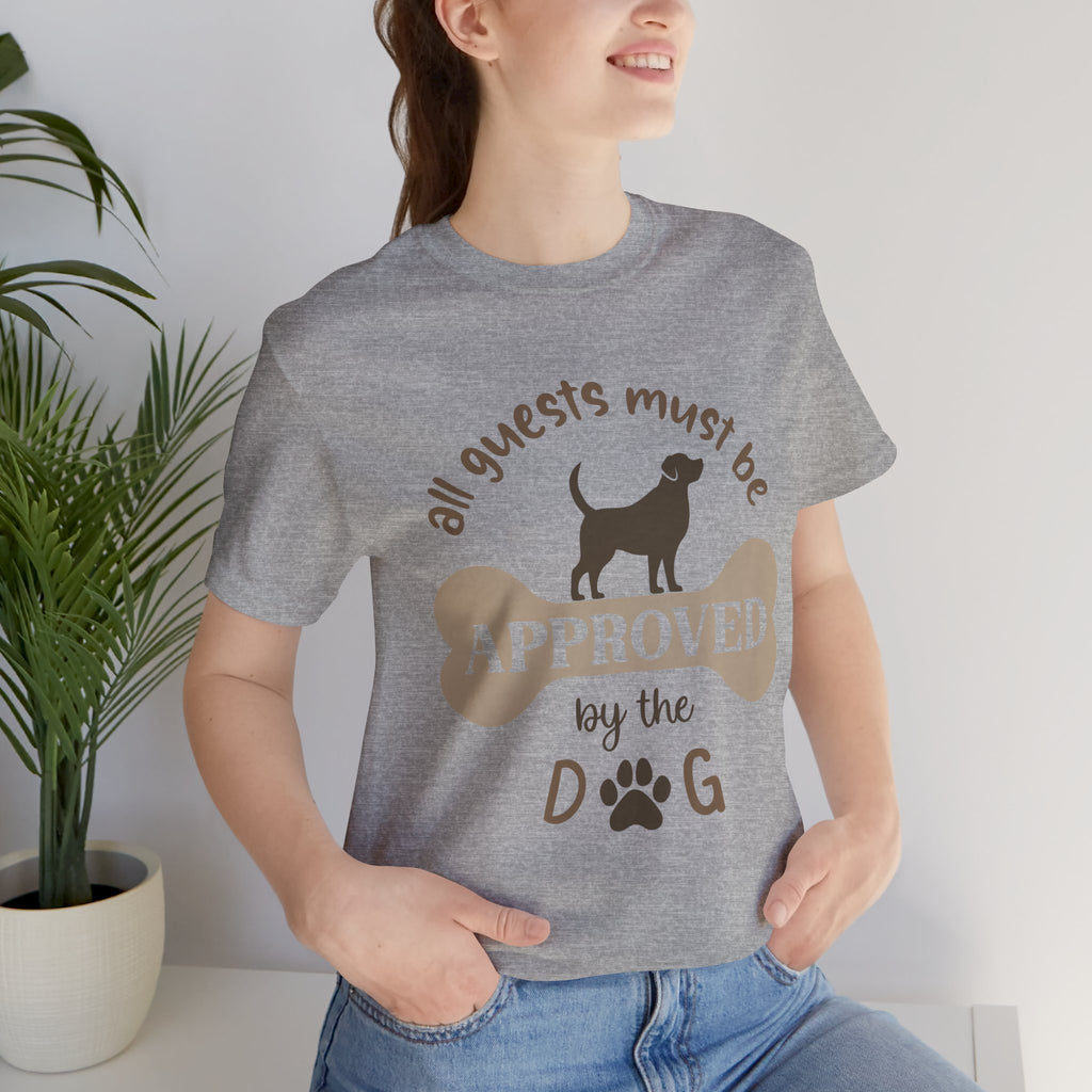 Person wearing a gray t-shirt with a dog-themed graphic and text.