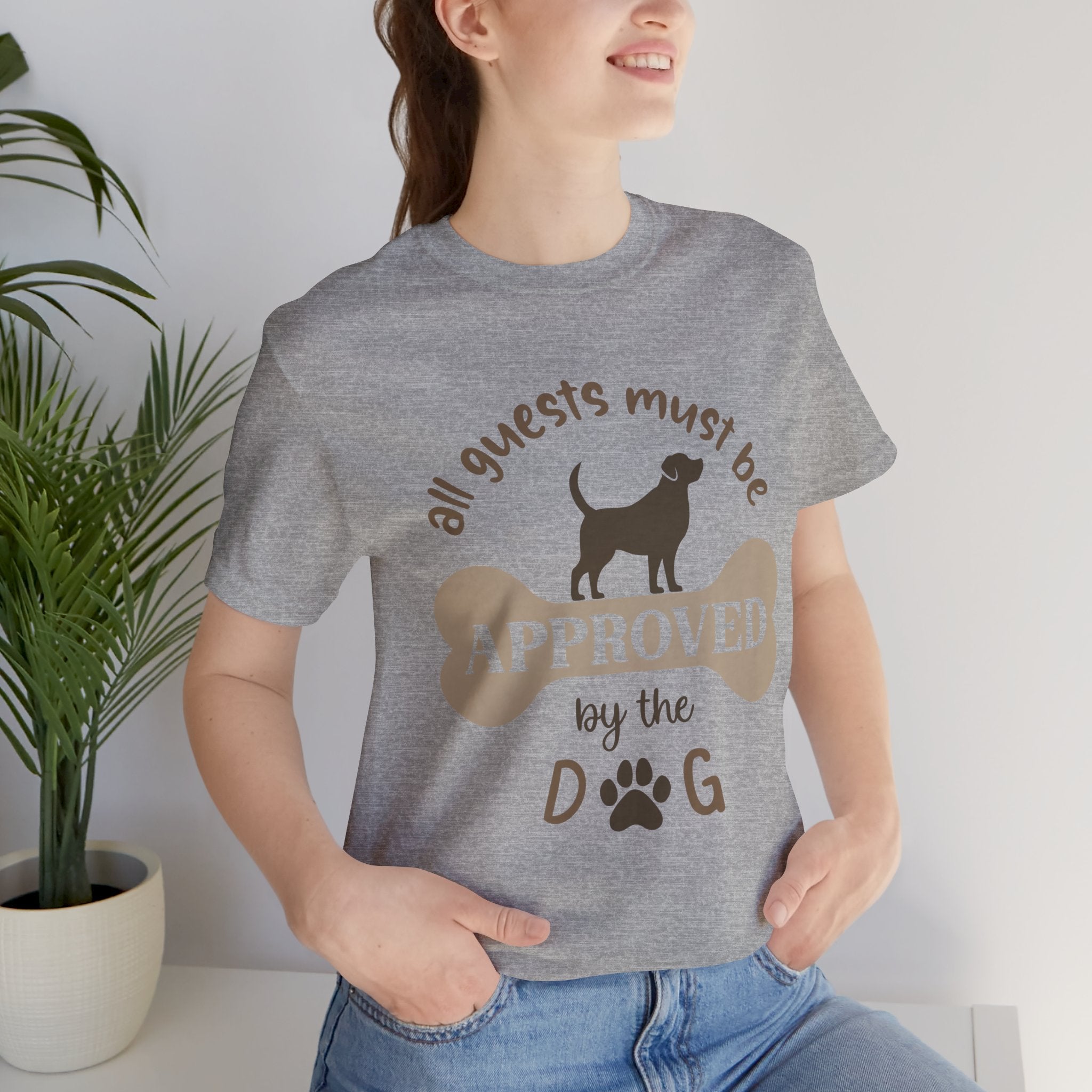 Person wearing a gray t-shirt with a dog-themed graphic and text.