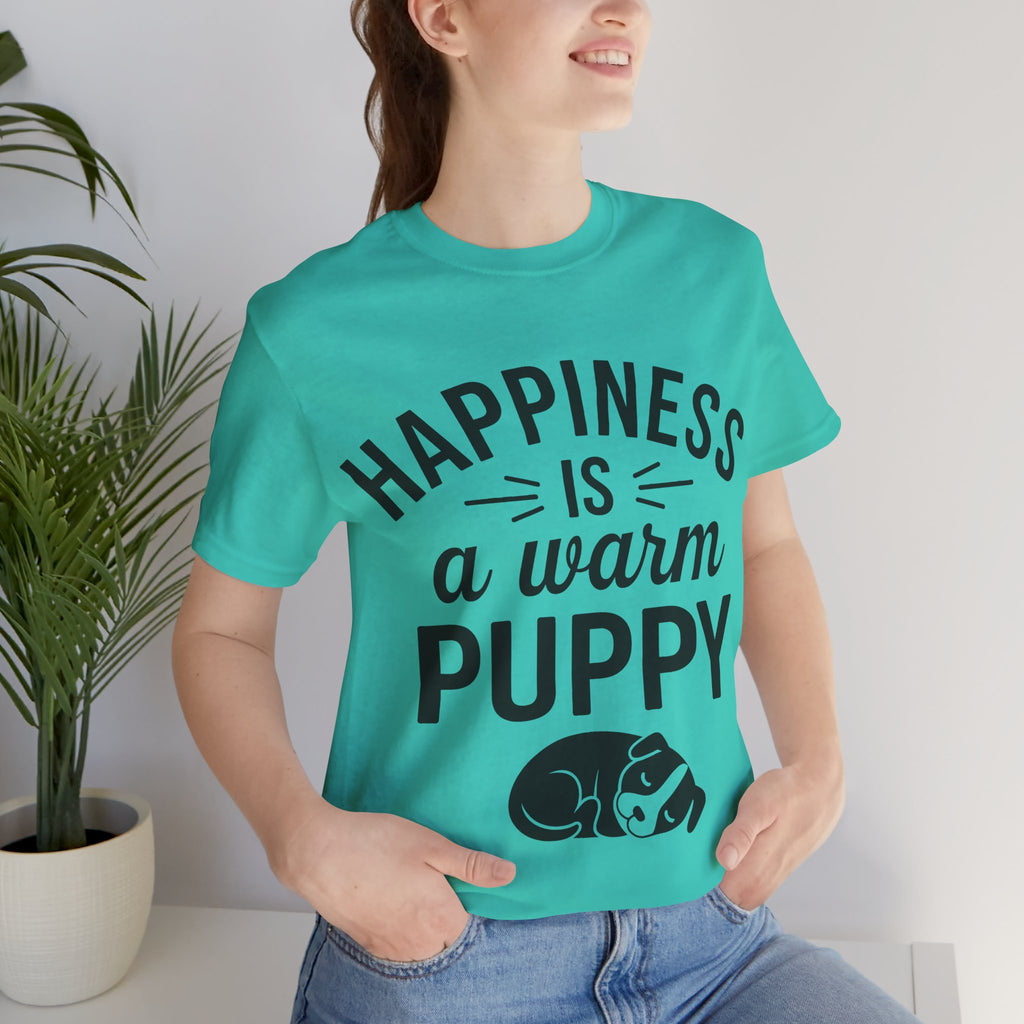 Person wearing a turquoise t-shirt with 'Happiness is a warm puppy' text and graphic.