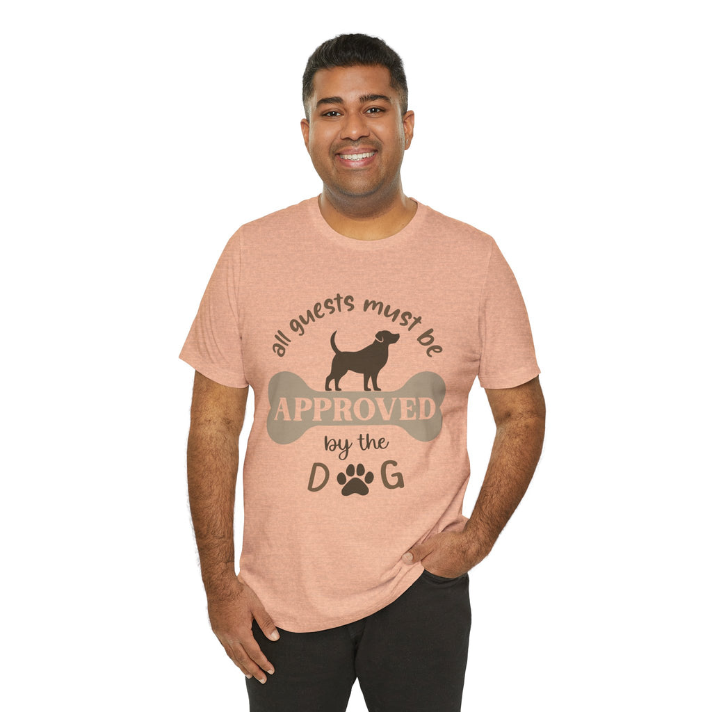 Man wearing a peach t-shirt with a dog-themed graphic and text on a white background