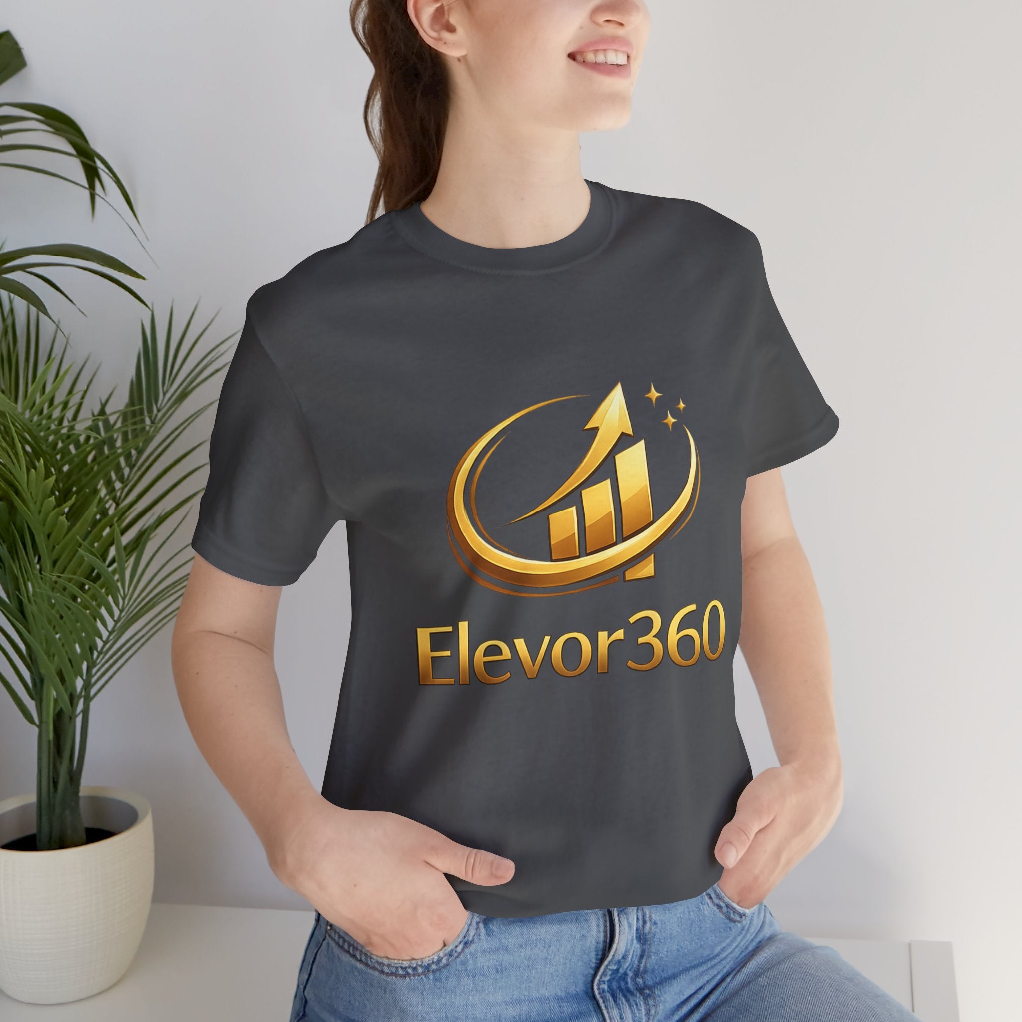 Person wearing a black t-shirt with 'Elevor360' logo in gold.