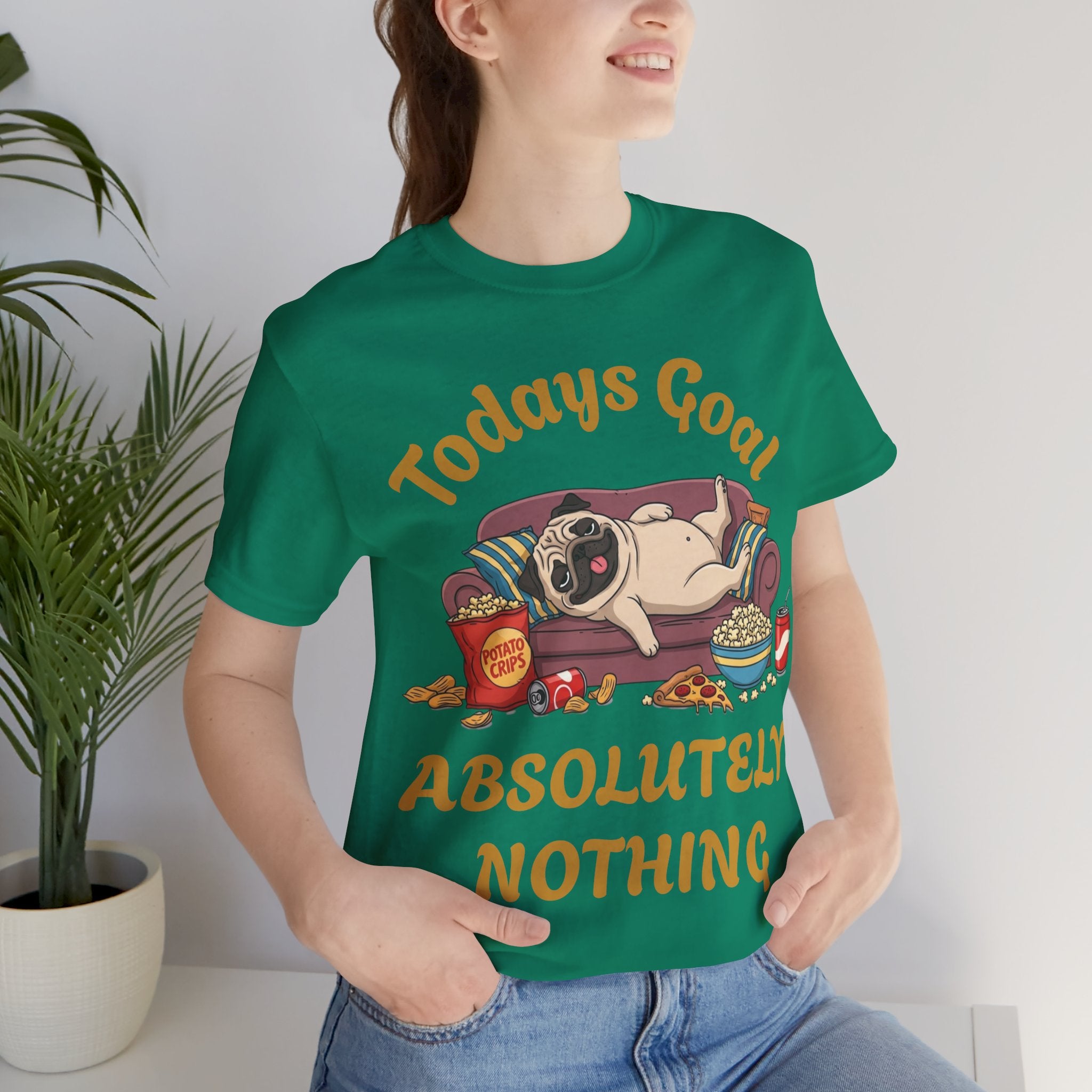 Person wearing a green t-shirt with a pug graphic and text in a casual setting