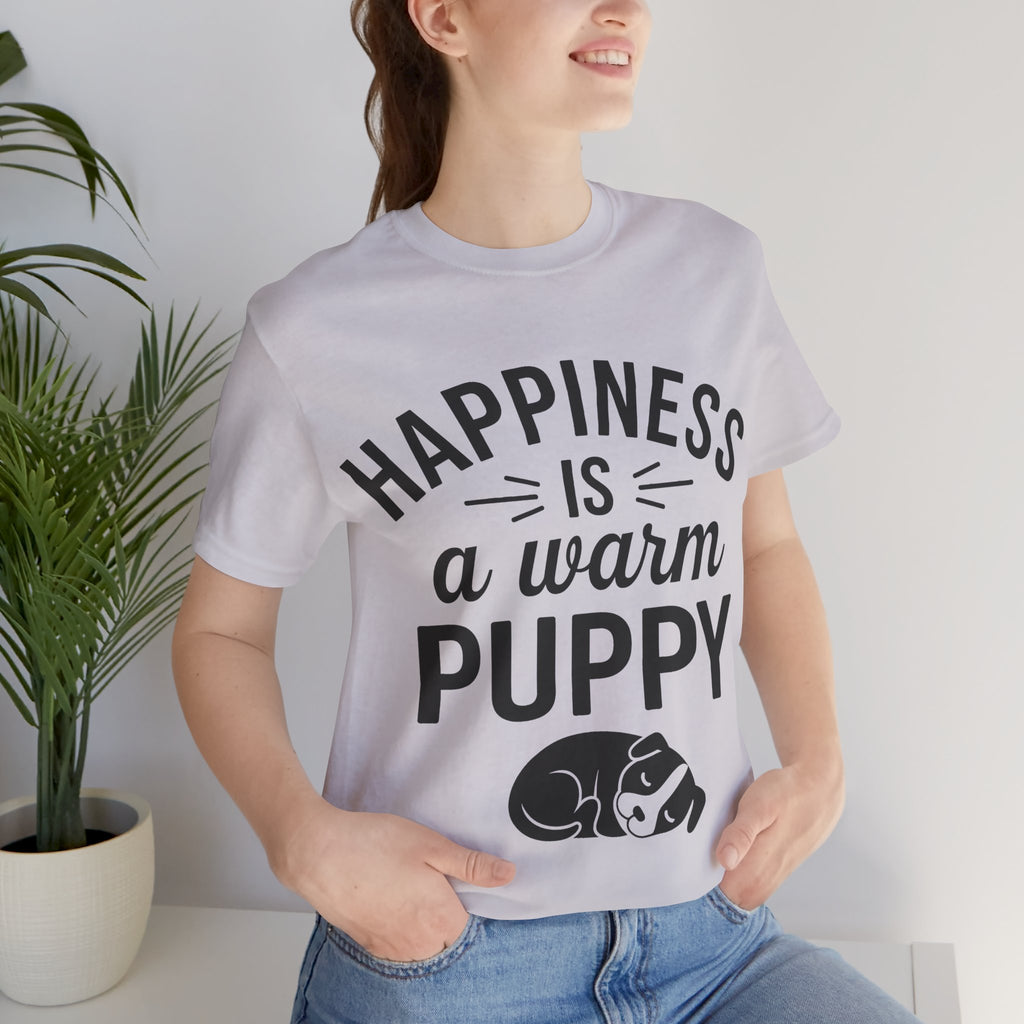 Person wearing a t-shirt with 'Happiness is a warm puppy' text and graphic.